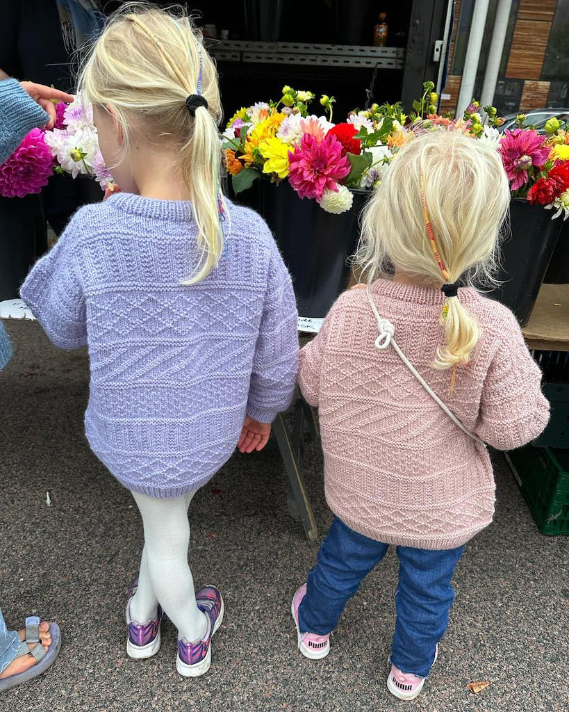 Piger iført Storm Sweater Junior i lyserød og lilla